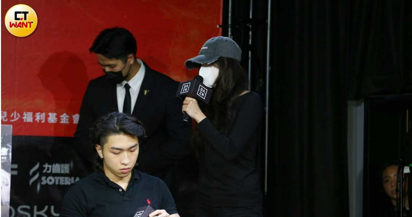 今記者會現場一位舉著「我是受害者」的女子突然走上台,指控孫生。(圖/蘇聖倫攝)