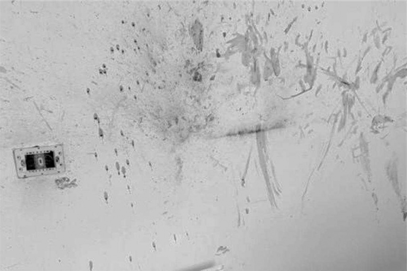 現場牆壁留有黑色火藥痕跡,警鑑識確認包裹以機械裝置引爆。(圖/翻攝畫面)