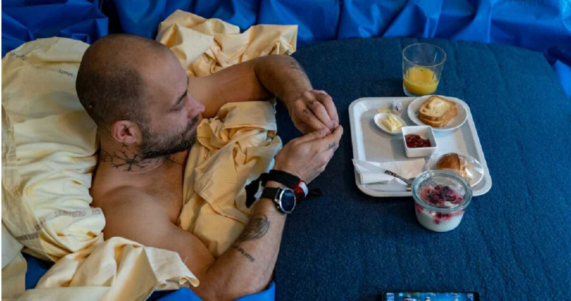 為了貼近無重力環境，志願者只能在躺著的姿勢下用餐。（圖／翻攝European Space Agency）