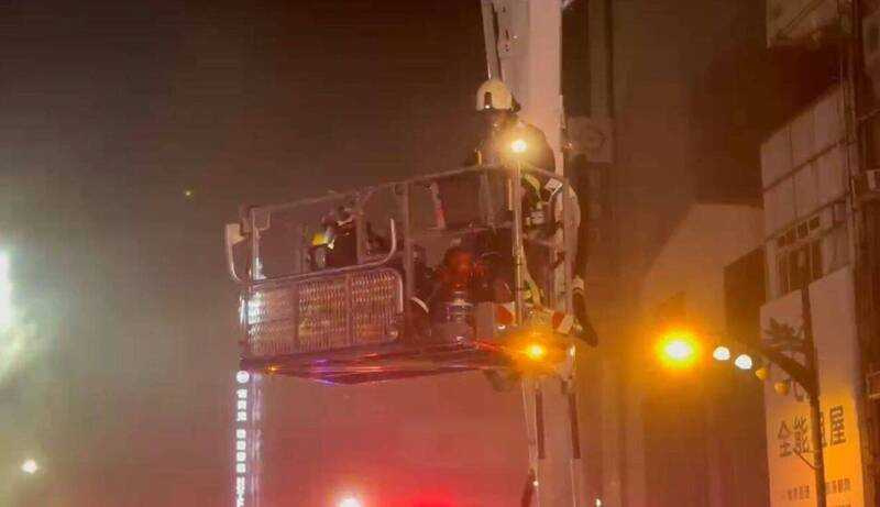 蕭家老小六口人受困屋頂,台中市消防局出動雲梯車,分四梯次,將傷者救下送醫,幸無大礙。(圖/消防局提供)