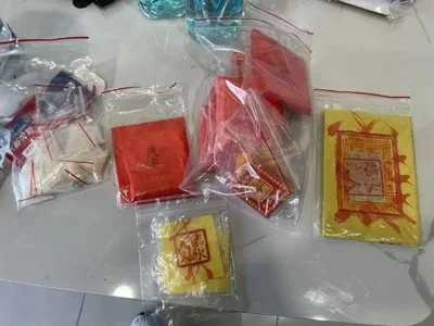 橋檢指揮警方攻堅,破獲跨國詐欺電信機房,發現犯嫌為求財求平安在門窗貼滿紙符還喝符水,求財避禍。(圖/警方提供)