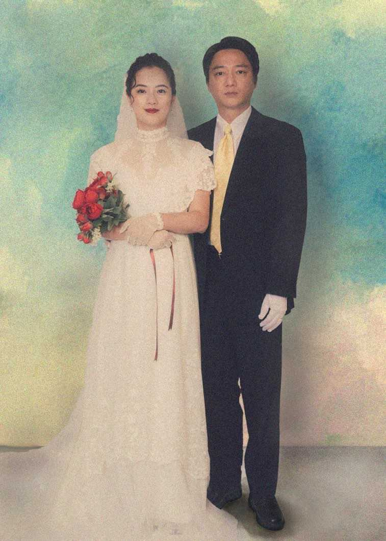 片中藍葦華(右)與高伊玲(左)的婚紗照,媽媽穿著白色婚紗塗大紅色口紅,爸爸站在媽媽旁邊,面無表情但眼神藏不住緊張神情,影迷直呼「很有年代感」。(圖/牽猴子提供)