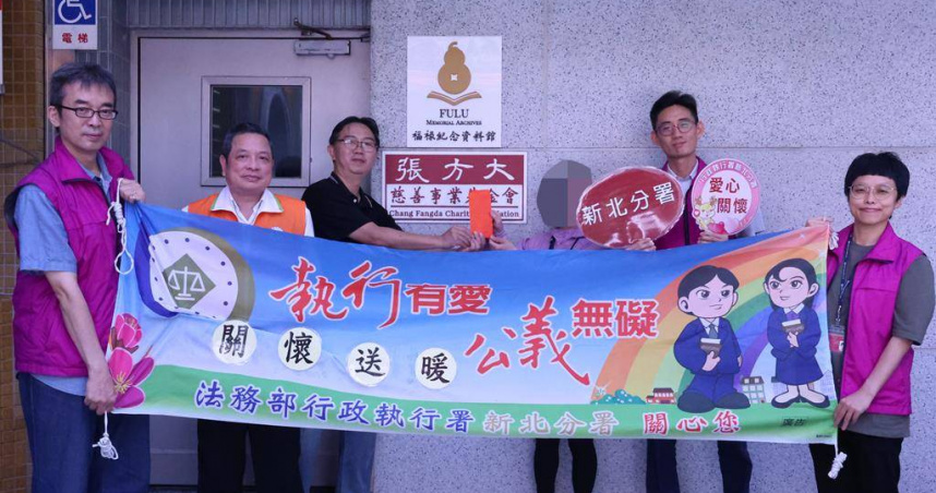 財團法人新北市私立張方大慈善事業基金會執行長張方大（左3）發給吳女（右3)急難救助金5000元。（圖／法務部行政執行署新北分署）