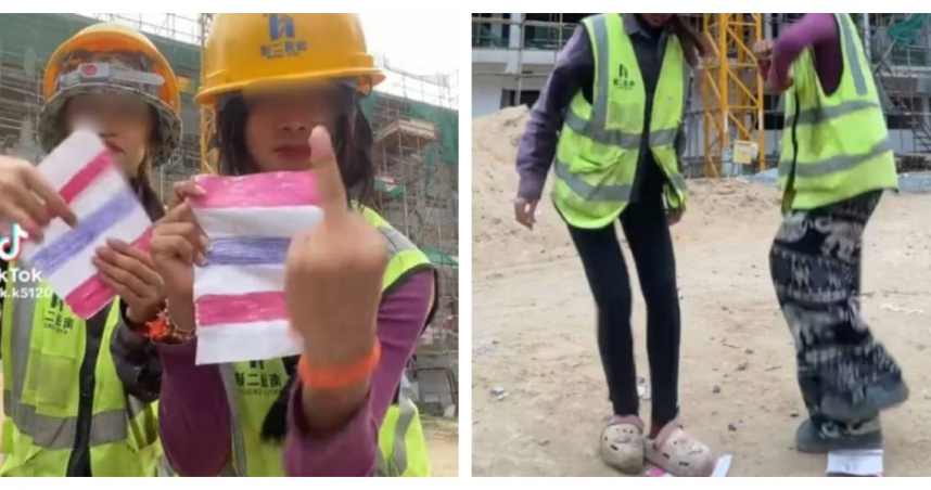 影片中可見兩名女子舉中指並踐踏泰國國旗，引起網友強烈反感。（圖／翻攝自TikTok）