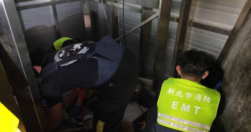 新北市石碇施工臨時電梯墜落，救護人員將電梯裡2名工人送醫。（圖／警方提供）