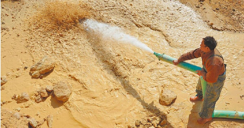 中國大陸祭出擴大稀土出口管制，衝擊全球市場。圖為江西省的工人在稀土礦場澆水。（圖／達志／路透社）