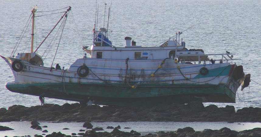 2025年8月27日澎湖縣／造船廠師傅26日登上礁石，檢視下午觸礁擱淺的漁船船底破損情形。（圖／中國時報許逸民攝）