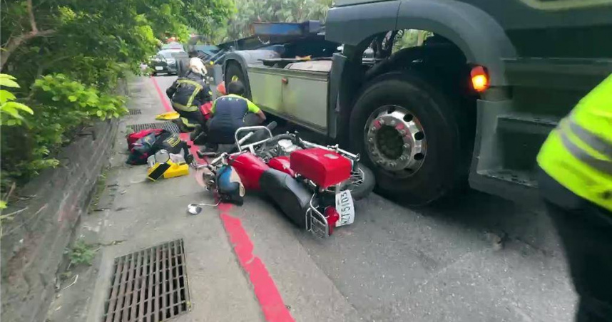 基隆市樂利三路與麥金路口8日下午5時許發生貨櫃車與機車的交通事故，機車騎士不明原因被捲進貨櫃車底。（圖／翻攝畫面）