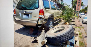 台南砂石車車輪滾落,沿路滑行砸毀停在路邊自小客保險桿。(圖/讀者提供)