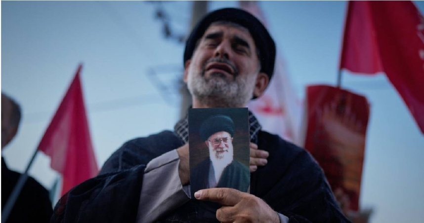 伊朗國民手中的照片為遇害的前伊朗最高領袖阿里哈米尼（Ayatollah Ali Khamenei）。（圖／達志／美聯社）